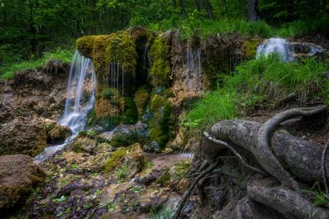 Waterfall in the middle of the mountains Stock Photos