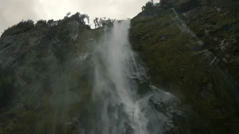 Waterfall mist flows out from rocky wall Stock Footage 140612004