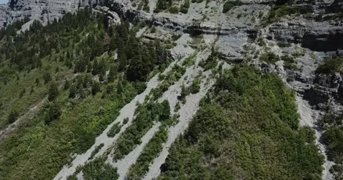 A waterfall with a mountain in the background Stock Footage 155513721