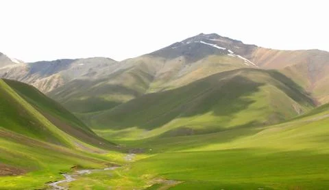 A waterfall with a mountain in the background Stock Photos