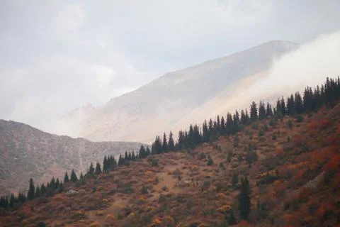 A waterfall with a mountain in the background Stock Photos