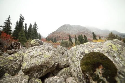 A waterfall with a mountain in the background Stock Photos