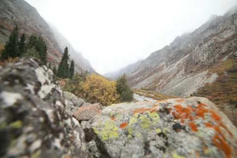 A waterfall with a mountain in the background Stock Photos