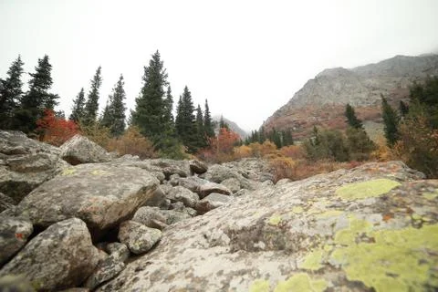 A waterfall with a mountain in the background Stock Photos