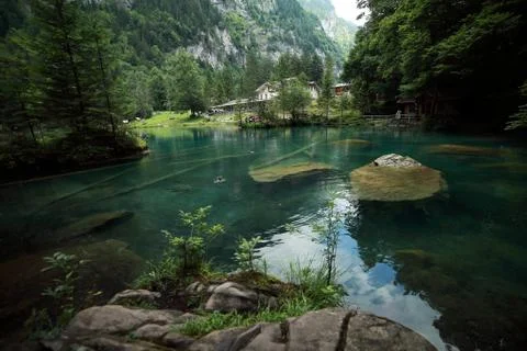 A waterfall with a mountain in the background Stock Photos