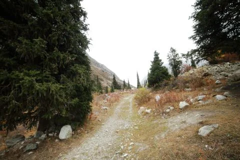 A waterfall with a mountain in the background Stock Photos