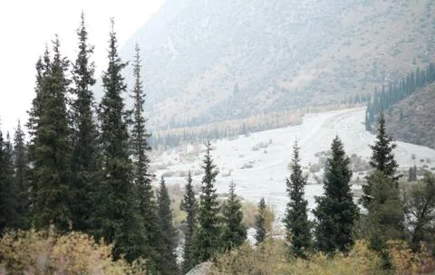 A waterfall with a mountain in the background Stock Photos