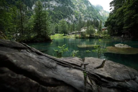 A waterfall with a mountain in the background Stock Photos
