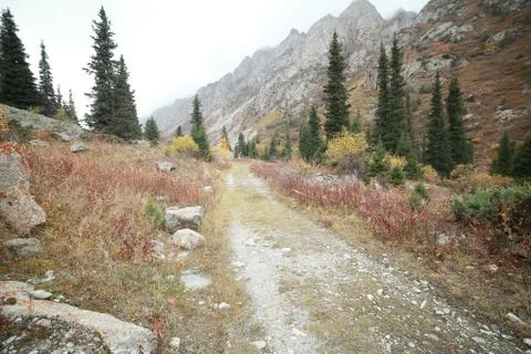 A waterfall with a mountain in the background Stock Photos