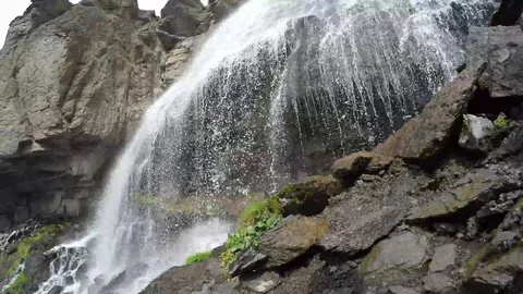 Waterfall from mountain between two rocks Stock Footage 118647831