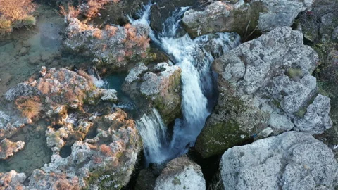Waterfall on mountain brook surrounded by rocks. Water falling in cascades Stock Footage 167575884