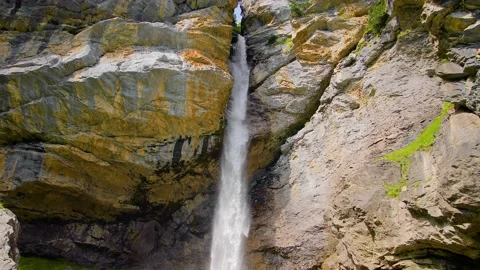 Waterfall on a mountain flowing between rocks in Switzerland - close view 4K Stock Footage 139801022