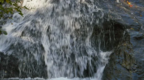 Waterfall on Mountain Flowing Over Rock Cliff During Autumn, 4K Stock Footage 56565351