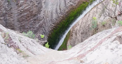 Waterfall in mountain, flows down splashes on moss of rock Stocks of water, eco Stock Footage 244821295