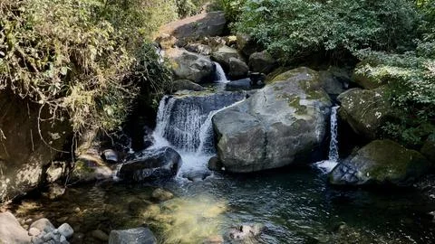 Waterfall in the mountain forest Stock Photos