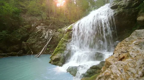 Waterfall in mountain forest with sun Video stock 43317113