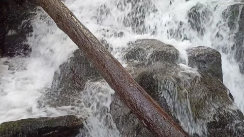 Waterfall in a mountain gorge in early spring Stock Footage 235345243
