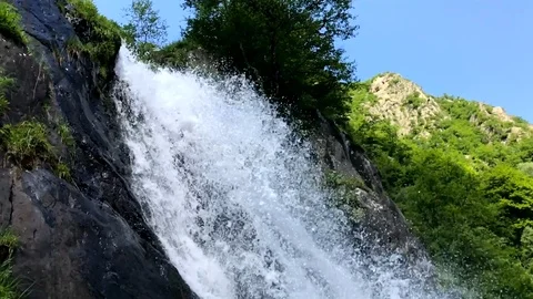 Waterfall in mountain landscape during a summer day Stock Footage 95913398