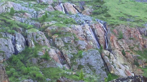 Waterfall on a mountain river flowing down from the high rocks Stock Footage 62285829