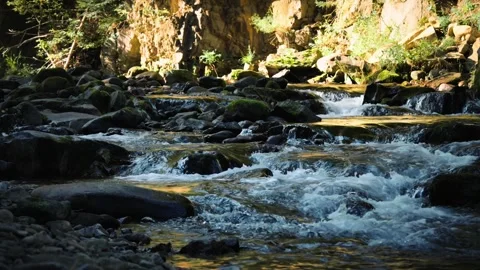 Waterfall on a mountain river, medium close-up Stockbeeldmateriaal 253467597
