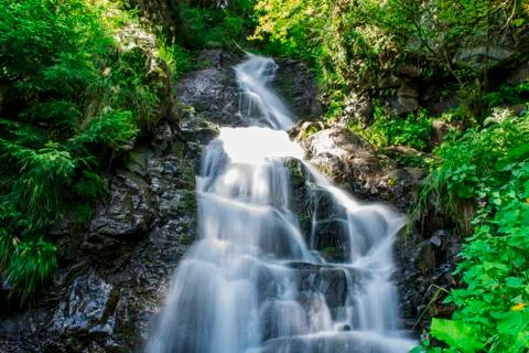 Waterfall on mountain river Stock Photos