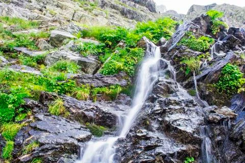 Waterfall on mountain river Stock Photos