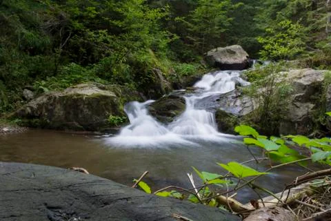 Waterfall on mountain river Stock Photos