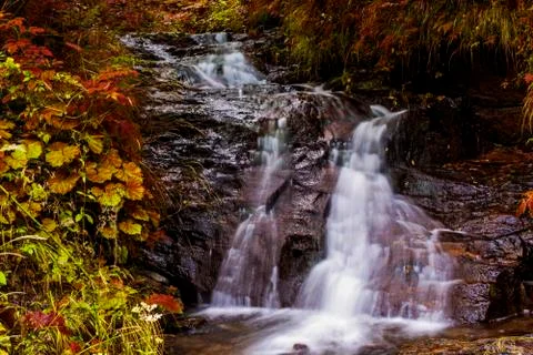 Waterfall on mountain river Stock Photos