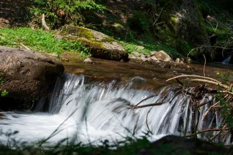 Waterfall on a mountain river Stock Photos