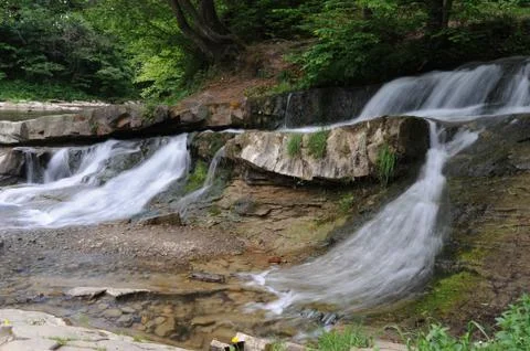 Waterfall on a mountain river Stock Photos
