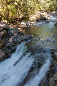 Waterfall of the mountain river Stock Photos