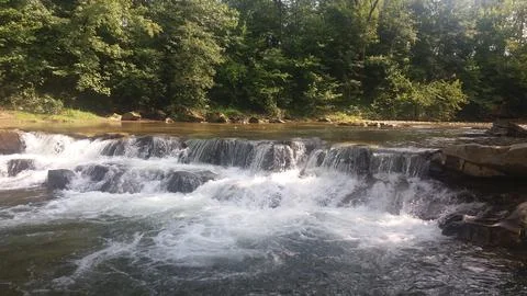 Waterfall on a mountain river Stock Photos