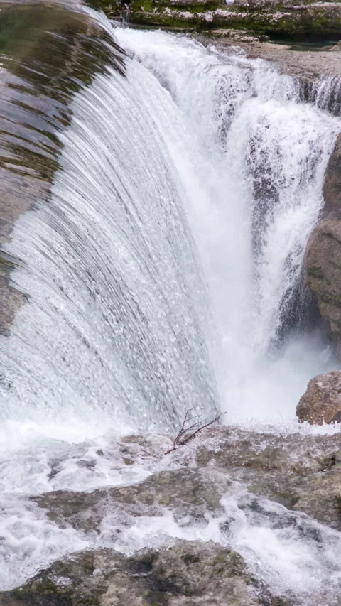Waterfall on mountain river surrounded by rock: water falling over vertical drop Stock Footage 268700993
