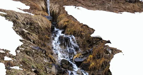 A waterfall on a mountain with snow Stock Footage 260605440