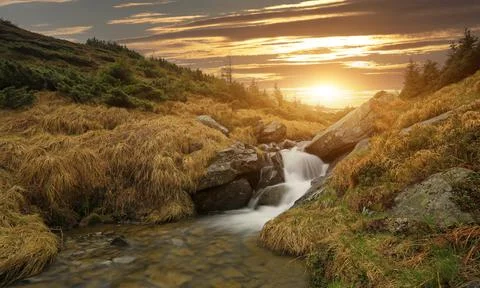Waterfall on mountain stream Stock Photos