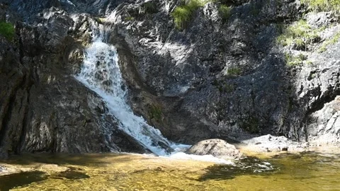 A waterfall from a mountain stream in summer (slow motion) Stock-Footage 219646751
