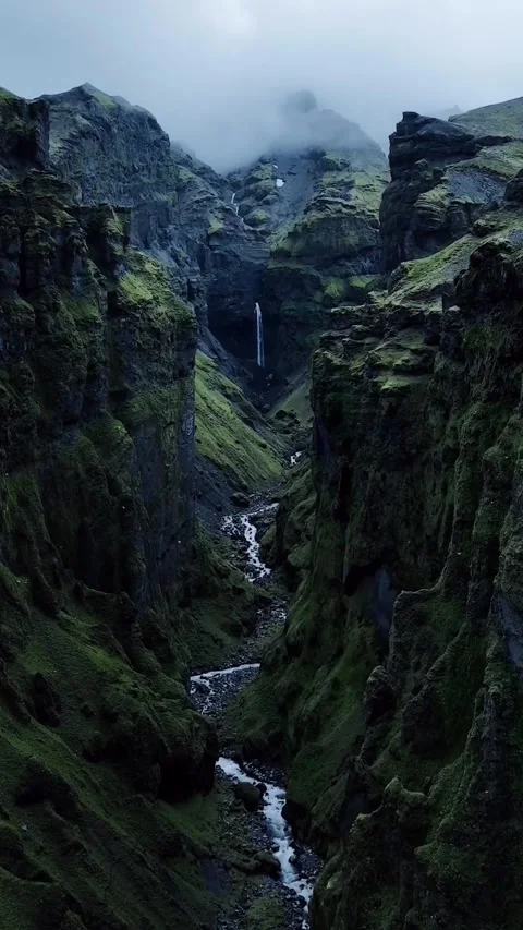 Waterfall in the mountains between green valley Stock Footage 275172745