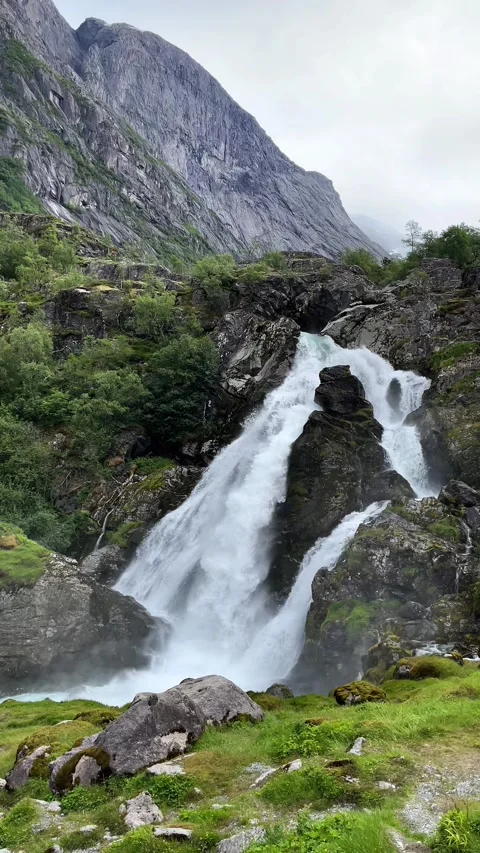 A waterfall from the mountains in Briksdalsbreen Stock Footage 337364970
