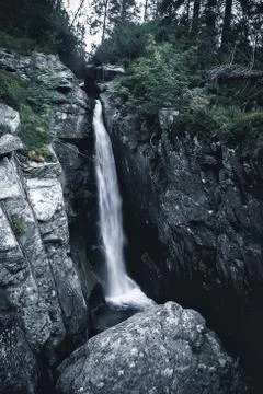 Waterfall in the mountains. Stock Photos