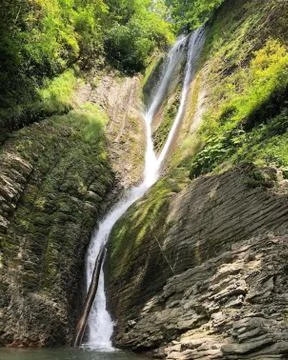 Waterfall in the mountains. Stock Photos