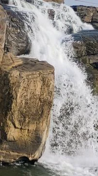 The waterfall in the mountains. Stock Photos