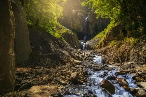 Waterfall in the mountains in summer Stock Photos