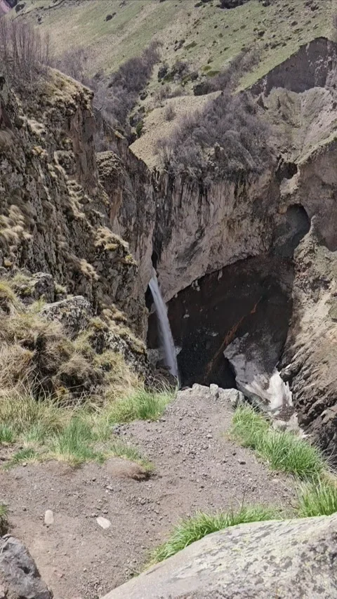 Waterfall in Mountains Surrounded by Rocks and Nature Stock Footage 331065678