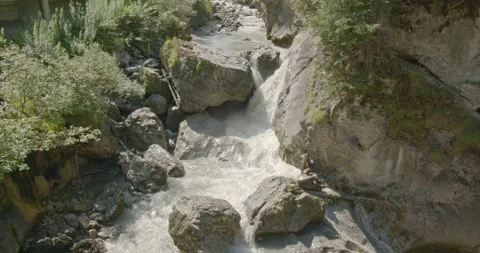 Waterfall in the mountains. Water flowing between road and rocks in the fores Video stock 144491082
