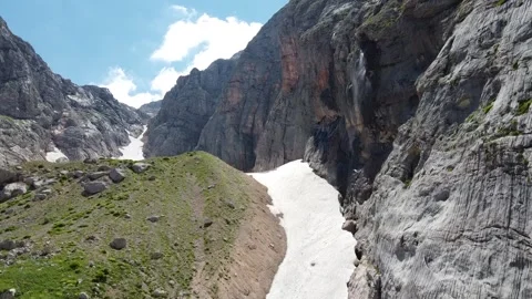 Waterfall in the mountains. The wind blows off jets of water. Aerial photography Stock Footage 137077432