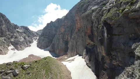 Waterfall in the mountains. The wind blows off jets of water. Aerial photography Stock Footage 137077454