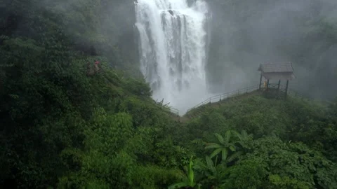 Waterfall in a natural rainforest in Laos Stock Footage 248660944