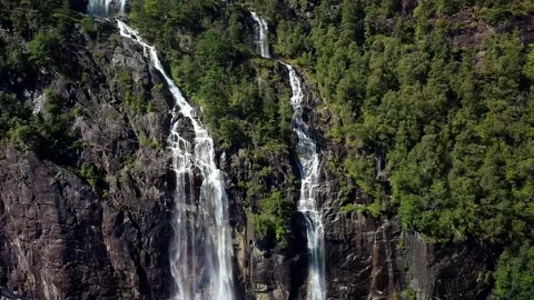 Waterfall next to trees in a rocky landscape Stock Footage 239551799