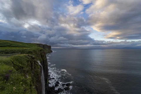 Waterfall by the ocean, dramatic sunset sky, 6k timelapse Stock Footage 255668651