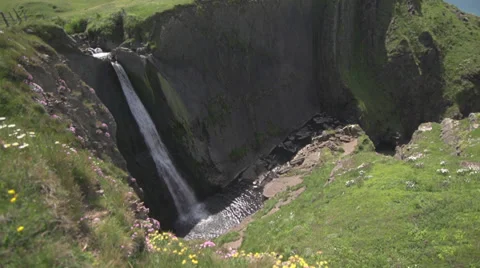 Waterfall by the ocean pan up Video stock 31745868